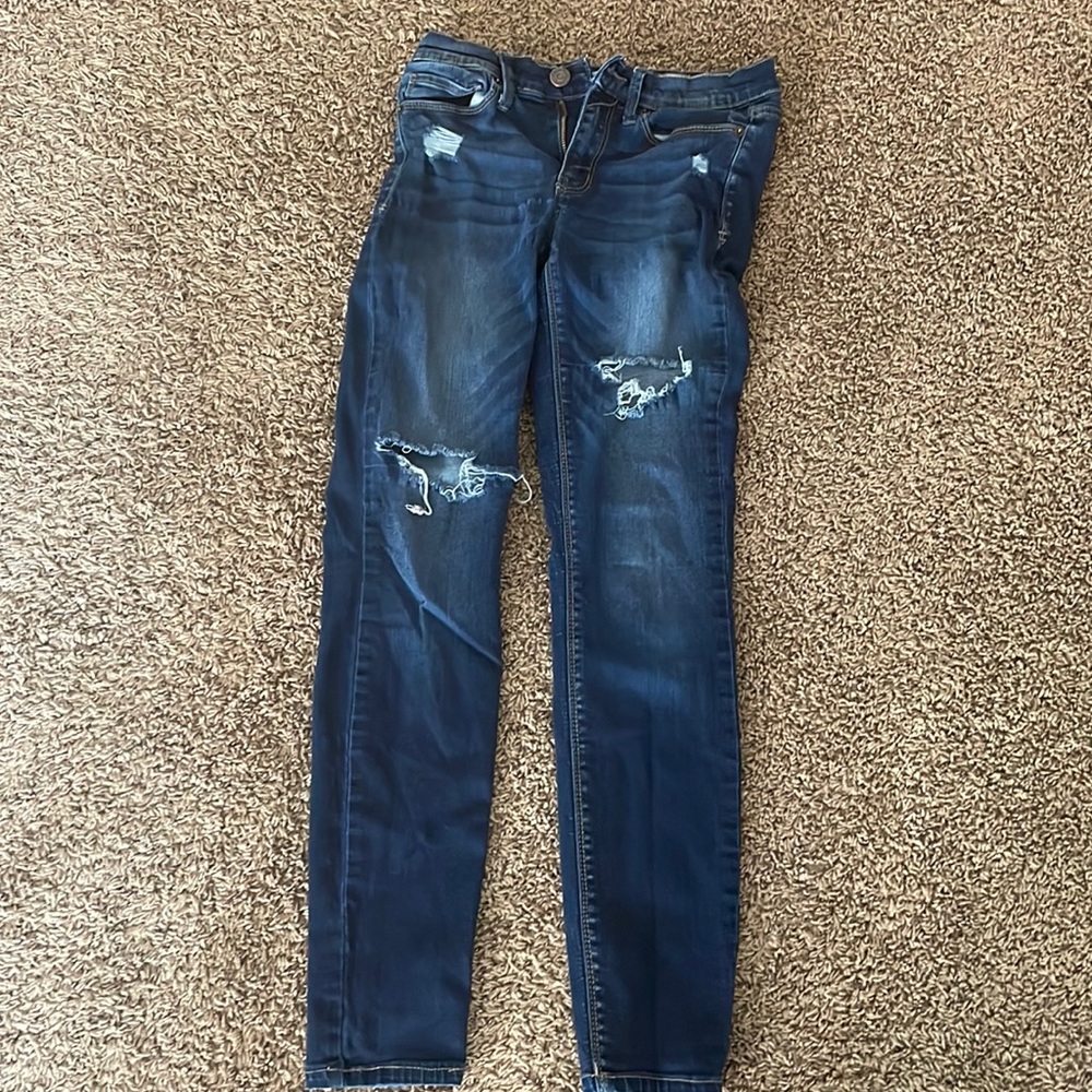 Dark blue low rise skinny size 5 has hole on the knee and thigh
